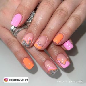 Orange And Pink Glitter Nails With A Different Design On Each