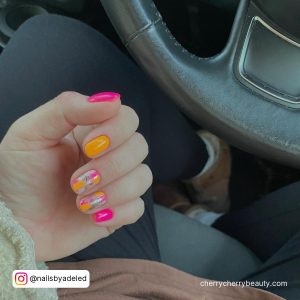 Orange And Pink Short Nails With Design On Two Fingers