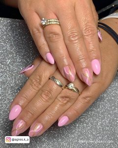 Pastel Pink Fake Nails With Swirls On Two Fingers