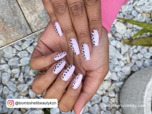 Pastel Pink Nails On Dark Skin With Print On Half Side Of Nail