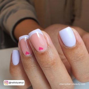 Pink And White Nails With Hearts In French Tip Design