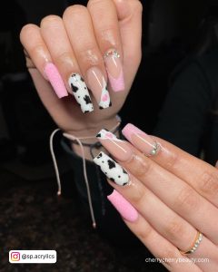 Pink Cow Print Acrylic Nails With Black Spots On Two Fingers