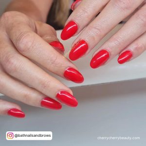 Plain Almond Red Acrylic Nails On White Surface