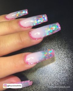 Pretty Clear Pink Acrylic Nails With Glitter And Flakes Over Black Surface
