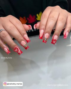Pretty Summer Acrylic Nails With Rhinestones And French Tips Over White Surface