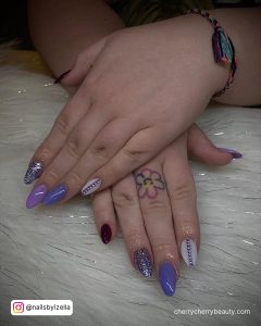 Purple Acrylic Nails With Glitter On One Finger