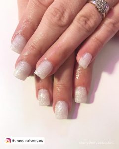 Shimmery Simple Cute Acrylic Nails Over White Surface