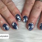 Short Acrylic Halloween Nails With White Ghosts On Blue Base Coat