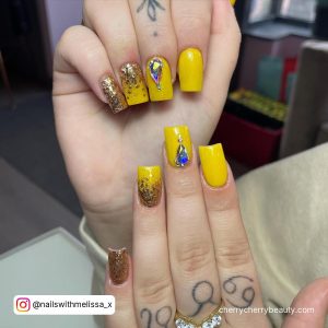 Short Acrylic Nails Yellow With Rhinestones And Golden Glitter