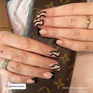 Short Black Gel Nails With Swirls On Two Fingers