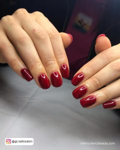 Short Dark Red Nails Acrylic On White Surface