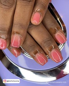 Short Square Pink Ombre Nails On A Purple Surface
