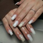 Simple Christmas Design For Acrylic Nails With Gold Flakes Over White Surface
