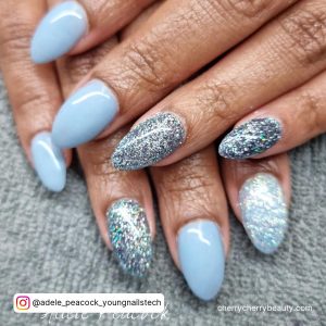 Simple Light Blue Acrylic Nail Designs With Glitter On Grey Clothe
