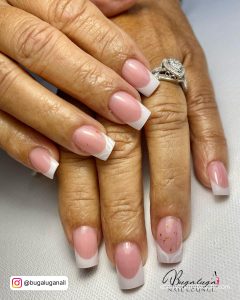 Simple Short French Tip Acrylic Nails Over White Surface
