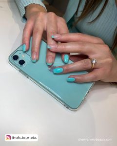 Simple Summer Pastel Acrylic Nails Holding And Iphone On A White Surface