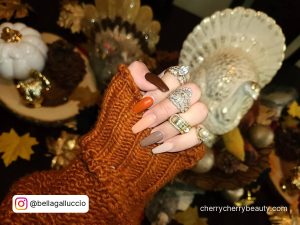 Thanksgiving Coffin Fall Acrylic Nails With Thanksgiving Decoration In Background