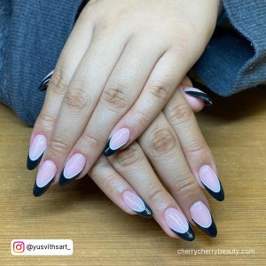 White And Black French Tip Outline Acrylic Nails Over Wooden Surface