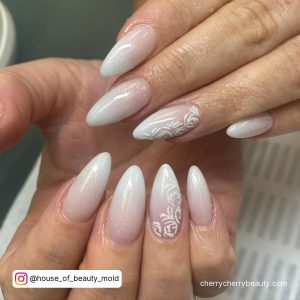White Ombre Acrylic Nails With Design On One Finger
