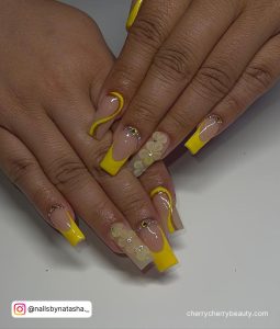 Yellow Acrylic Nails With Design On Each Finger