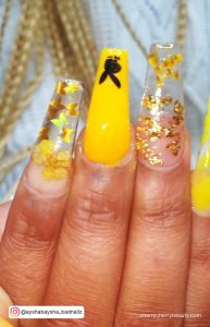 Yellow Acrylic Nails With Glitter And Black Design