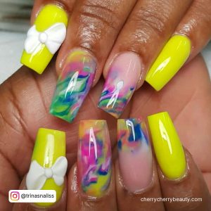 Yellow Nails Acrylic With Bow On One Finger And Rainbow Colors On Two