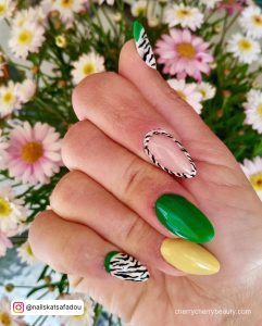 Zebra-Print Acrylic Almond Nails With Flowers In Background