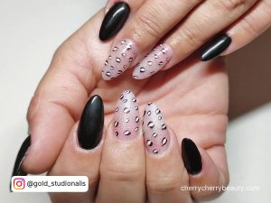 Almond Nails Black And White With Design On Two Fingers
