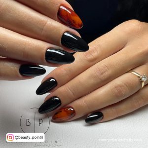 Almond Shaped Black Nails With Marble Design On Index Finger