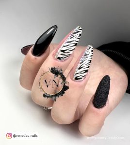 Black Acrylic Nails With Glitter With Zebra Print Of Two Fingers