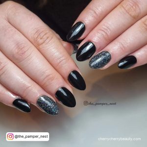 Black Almond Nails With Glitter On Ring Finger