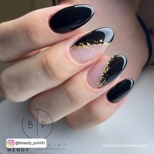 Black And Gold Almond Nails For A Fancy Look