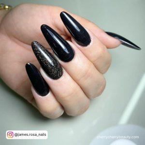 Black And Gold Almond Shaped Nails With Glitter