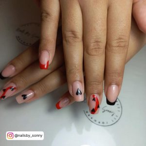 Black And Nude Acrylic Nails With Red Tips