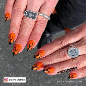 Black And Orange Flame Nails On Stiletto Shape