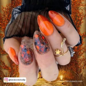 Black And Orange Halloween Nails In Stiletto Shape