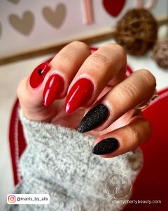 Black And Red Glitter Nails In Stiletto Shape
