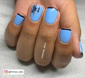 Black And Sky Blue Nails With Design On Ring Finger