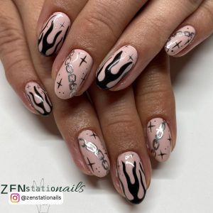 Black Flame Acrylic Nails With Nude Base Coat And Silver Design