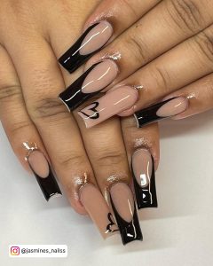 Black French Tip Nails With Hearts On Ring Finger