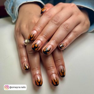 Black Nails With Orange Flames In Almond Shape