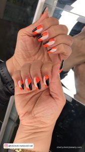 Black Orange And White Nails In Almond Shape