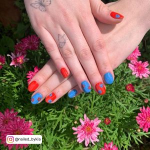 Blue And Red Acrylic Nails With Flowers