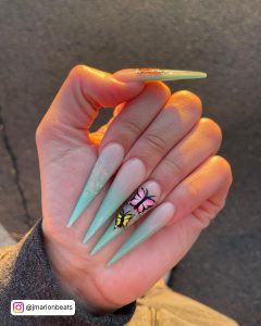 Blue Nail Ombre In Stiletto Shape With Butterflies