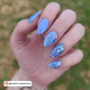 Blue Sparkly Nails In Stiletto Shape