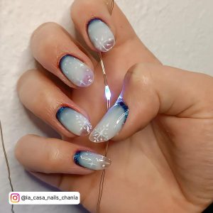 Blue To White Ombre Nails With Snowflakes