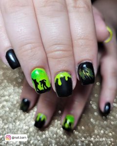 Bright Green And Black Nails With Men On Ring Finger