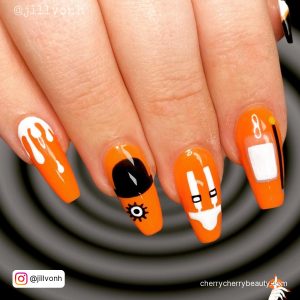 Coffin Black And Orange Nails With A Different Design On Each Finger