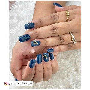 Dark Blue Nail Color With Golden Design On Ring Finger
