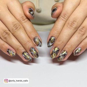 Gold And Black Marble Nails In Almond Shape